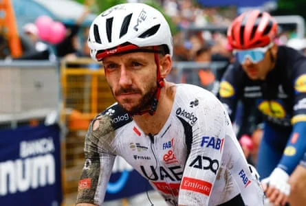 A bloodied Adam Yates crosses the line.